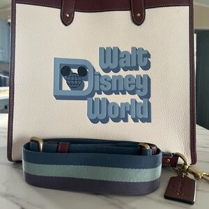 COACH Disney Cream Tote with Blue Logo and Burgundy Trim.